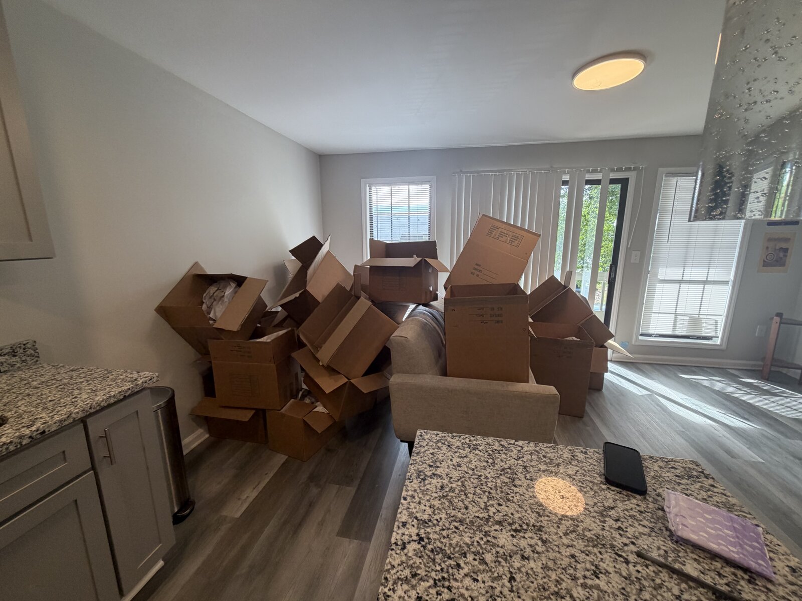 Dozens of empty and unfilled moving boxes left stacked in the apartment after consolidating