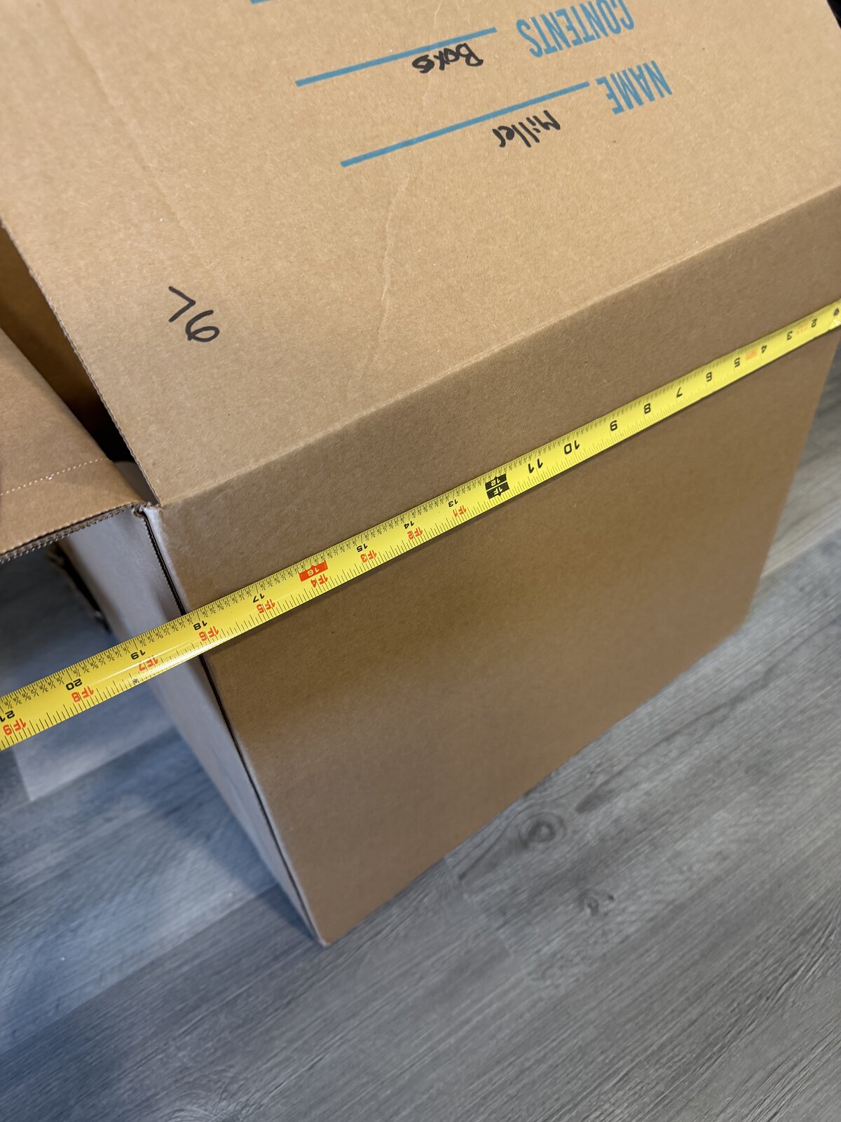 A tape measure showing the same box is about 18 inches wide